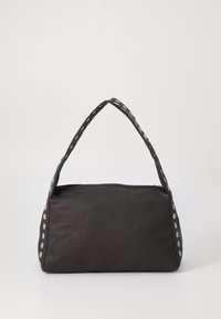 Black handbag with a rectangular shape, textured material, and a rounded handle featuring silver circular accents along the edges.