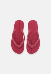Red flip-flops with a textured sole and flexible thong straps, featuring a heart and "love" printed on the footbed.