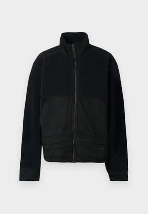 Black jacket featuring a structured design with a fleece upper and smooth fabric lower. High collar and front zipper closure present.