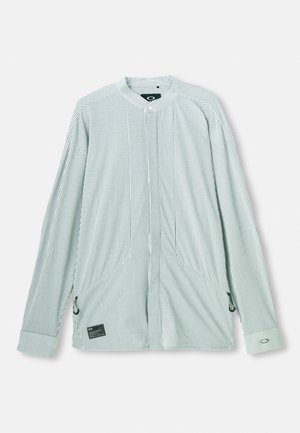 Žaliai ir baltai dryžuota ilgarankovė palaidinė. Su mandarinų apykakle, šoninėmis rišimo juostelėmis ir prekės ženklo etikete priekyje. Lengvas audinys.