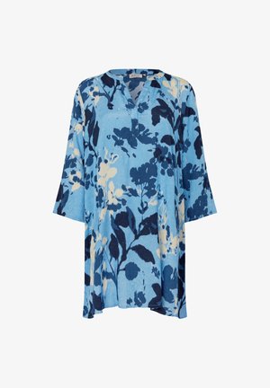 Tunique bleue à motifs floraux bleu foncé et blanc, col en V, manches trois-quarts, coupe ample. Tissu à la texture douce.
