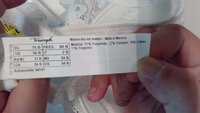 Biely dámsky podprsenka bez tvarovania s označením "Amourette WHP." Materiál: 51 % polyamid, 22 % elastan, 16 % bavlna, 11 % polyester. Vyrobené v Maroku.