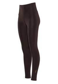 Leggings neri a vita alta, a lunghezza completa, con dettagli delle cuciture sottili e un piccolo logo dorato vicino alla caviglia su uno sfondo bianco.