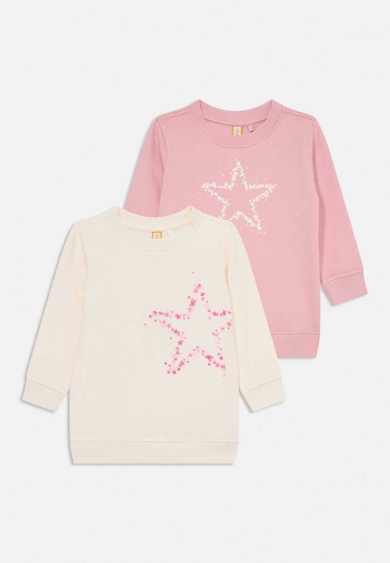 Dos sudaderas: una en color crema con un diseño de estrella rosa, y otra rosa con un diseño de estrella blanca. Ambas tienen mangas largas y cuellos redondos.