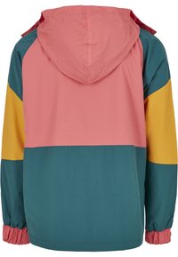 Vue arrière d'une veste à capuche avec des blocs de couleur en rose, turquoise et jaune, dotée de poignets élastiques aux manches.