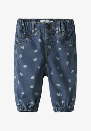 Pantalon en denim à base bleue, avec un motif répété de formes arrondies gris clair, des poignets élastiques et un design classique à cinq poches.