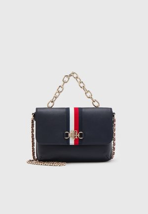 Navy blue faux leather handbag with a front flap, gold hardware, and a chain strap. Features red and white stripes across the front.