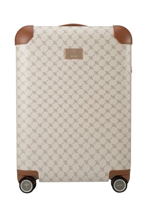 Cream hard-shell suitcase with tan leather corners and handle, featuring a repeating fan pattern and two black wheels with logo.