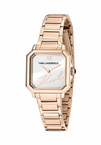 Orologio ottagonale in oro rosa con quadrante bianco, lancette argento e firma distintiva. Il cinturino è composto da anelli di metallo collegati per una finitura metallica.