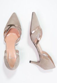 Pointed-toe high-heeled shoes in light taupe suede with metallic accents and cut-out side details. Slim heel adds a sleek silhouette.