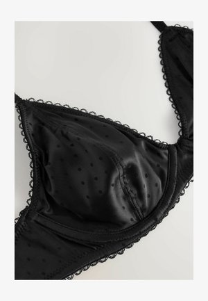 Zwarte beha met stippenpatroon, satijnen afwerking, kantafwerking langs de randen, en cups ontworpen voor vormgeving.