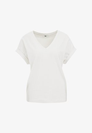 Fehér V-nyakú póló rövid, felgöngyölt ujjal, textúrált anyaggal, finom mintázattal. Egyenes alja és laza szabása van.