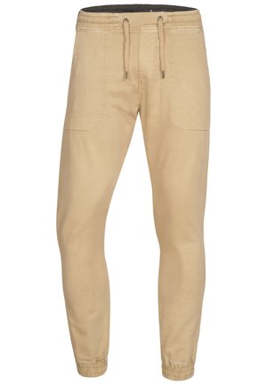 Beige Jogginghosen mit einem Kordelzugbund, elastischen Bündchen und Seitentaschen. Hergestellt aus weichem, leichtem Stoff mit glatter Textur.