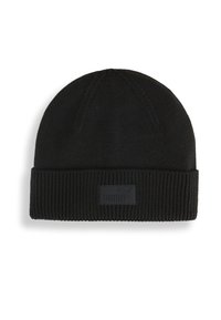 Black knit beanie with a ribbed texture, featuring a fold-up cuff and a black rubber logo patch on the front.
