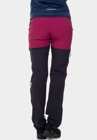 Two-tone outdoor pants with a maroon upper section and black lower section, featuring side zippers and durable fabric for outdoor activities.