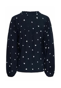 Blouse bleu marine avec un motif de cœurs blancs. Dotée de longues manches bouffantes et d'un col froncé. Le tissu doux offre une coupe décontractée.