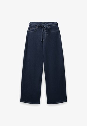 Dunkelblaue, weit geschnittene Denim-Hosen mit einem Kordelzugbund. Verfügt über Vordertaschen und contrasting Nähten entlang der Nähte.