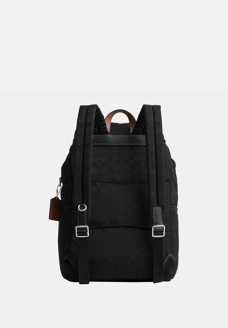 Black backpack with padded adjustable straps, leather handle, and subtle patterned fabric shown from the back against a gray background.