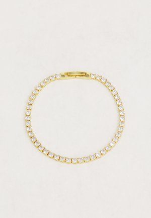 Gouden armband met een rij heldere, ronde kristallen in een klemzetting, voorzien van een veilige sluiting.