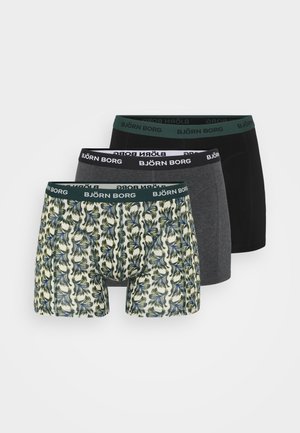 Three pairs of men's boxer briefs: one with a green, blue, and yellow leaf pattern; one dark gray; one solid black. All have branded waistbands.