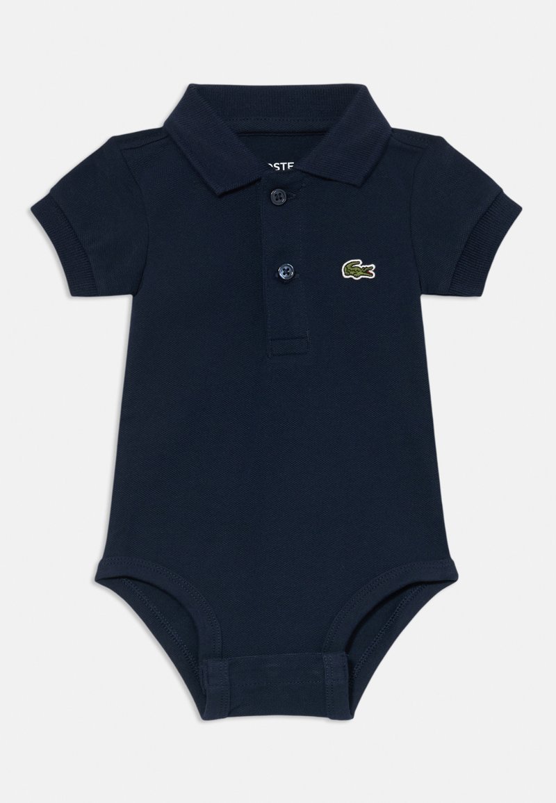 Polo body z navy modre barve, izdelan iz teksturiranega bombaža, z ovratnikom in dvema gumboma za zapiranje, okrašen z majhnim zelenim logotipom.