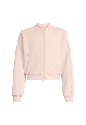 Sudadera corta rosa claro con cuello alto, cremallera frontal, dos bolsillos laterales y puños acanalados. La tela parece suave y tersa.