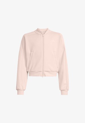 Bluză roz deschis, scurtă, cu guler înalt, fermoar frontal, două buzunare laterale și manșete elastice. Țesătura pare moale și netedă.