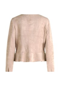 Beige mockaskjorta med långa ärmar, peplumsläp, slät textur och minimalistisk sömdetalj på baksidan. Inga synliga stängningar eller utsmyckningar.