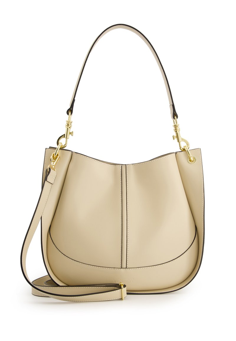 Beige leather shoulder bag with a curved top, raised seams, black edging, and a detachable strap. Gold hardware accents add detail.