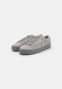 Gray suede sneakers with a smooth rubber sole, flat laces, and embroidered logo on the side. Rounded toe and padded collar for comfort.