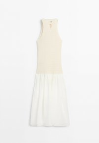 Sleeveless off-white dress with knit top and pleated fabric skirt, featuring keyhole cutouts on the upper back.