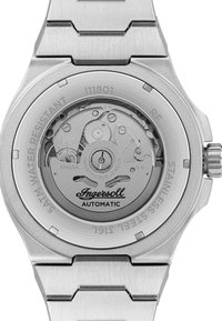 Zilveren roestvrijstalen horloge met automatische beweging. Kenmerken zijn een transparante achterzijde die de tandwielen toont, het "Ingersoll"-logo en waterdichtdetails.