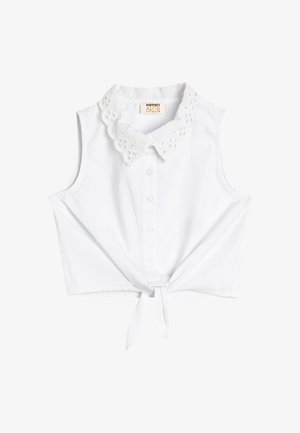 Hvid ærmeløs bluse med en blomsterdetalje krave i blonde, med knaplukning foran og en knude i kanten. Fremstillet af letvægts bomuldsmateriale.