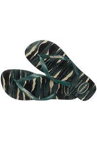 Zelene in črne natikače s teksturirano podplatom, z zelenimi trakovi in logotipom "Havaianas" na podplatu.