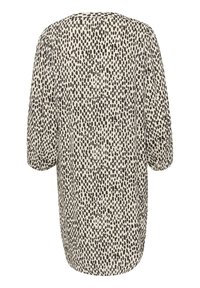 Chemise légère avec un col rond, des manches courtes bouffantes et un motif à pois noir et crème sur un tissu texturé.