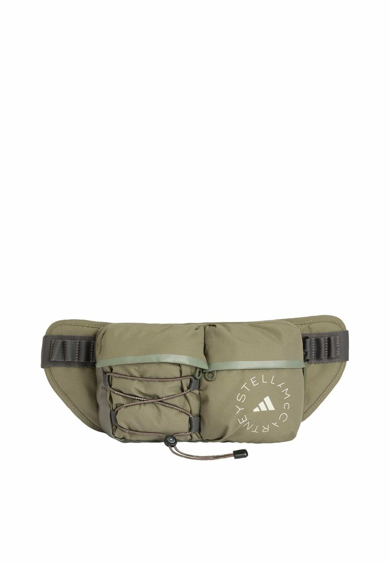 Olive green waist bag with textured fabric, adjustable strap, front bungee cord, and printed logo detail. Compact, functional design for outdoor use.