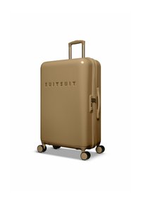 Harde koffer in glanzend beige, met een uittrekbare handgreep, vier spinnerwielen en een reliëf "SUITSUIT" logo aan de voorkant.
