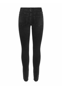 Sorte skinny jeans med høy midje. Laget av denim, med fem lommer og en jevn, litt falmet tekstur.