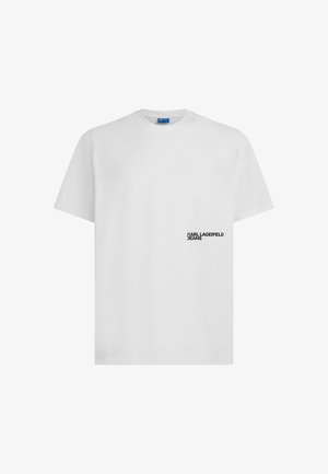 Biele tričko s krátkym rukávom a okrúhlym výstrihom, s malým čiernym nápisom "KARL LAGERFELD JEANS" na spodnej ľavej prednej strane.