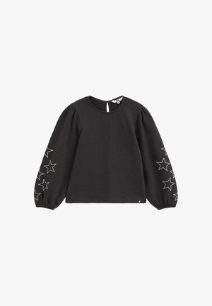 Blouse noire à manches longues avec manches bouffantes, contours d'étoiles blancs sur chaque manche, poignets élastiques et petite fermeture par bouton au dos.