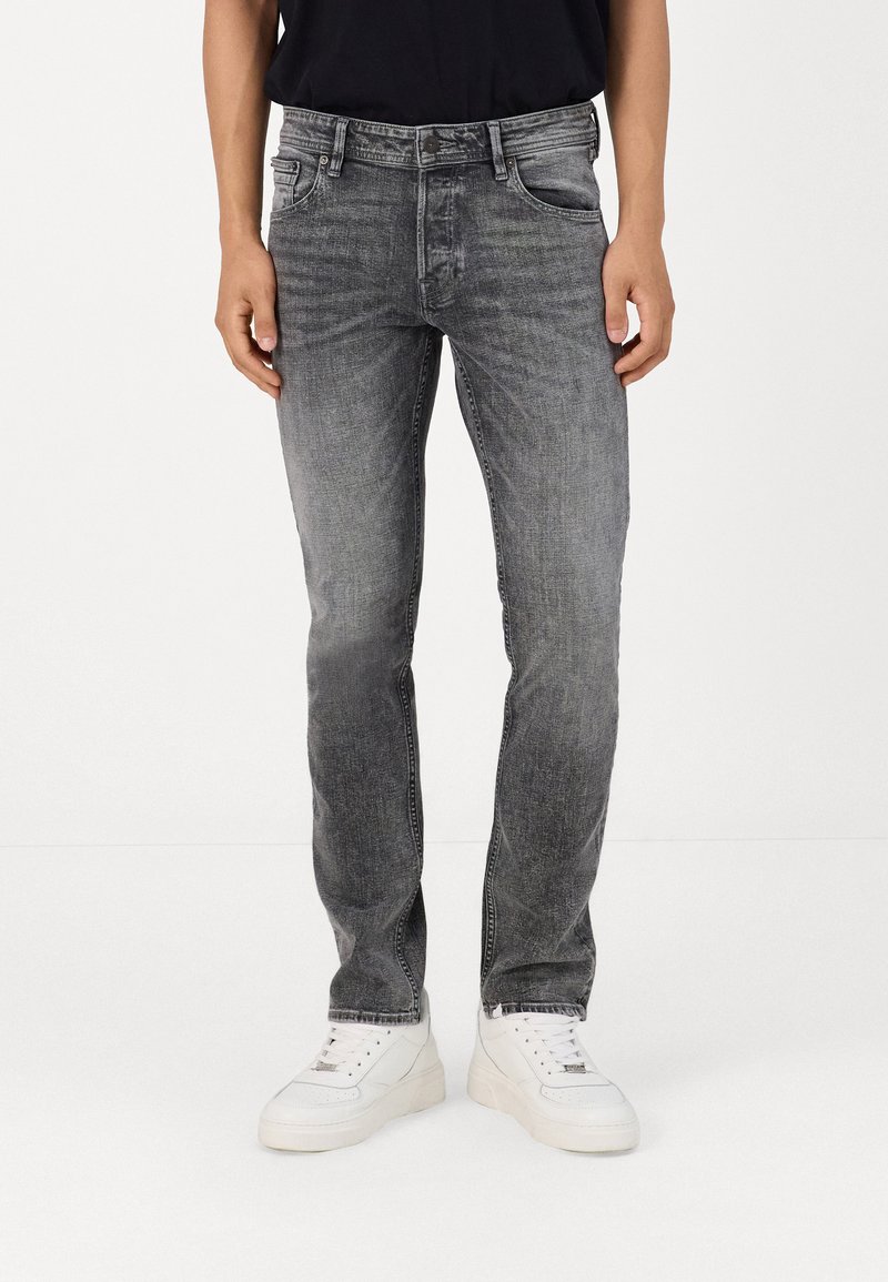 Grijze denim jeans met een slim fit, vervaagde textuur, vijf zakken ontwerp en een subtiele was effect, gecombineerd met witte sneakers.