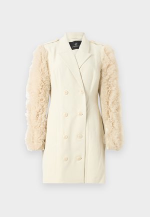 Kreminės spalvos dvigubo užsegimo švarkas su pūsto, skaidraus bežinio audinio rankovėmis. Yra dideli mygtukai ir pritaikytas siluetas. Paprastas ir elegantiškas dizainas.