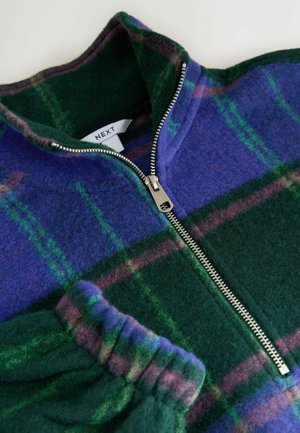 Fleece pullover in blue, green, and purple plaid pattern. Features a high collar and silver zipper hardware, with ribbed green cuffs.