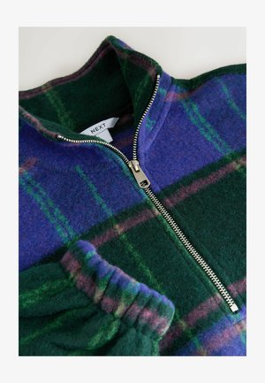 Pullover in pile con motivo a quadri blu, verde e viola. Presenta un colletto alto e una chiusura lampo argentata, con polsini verdi a costine.
