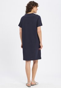 Navyblaue, kurzärmelige, knielange Robe aus weichem Stoff mit lockerer Passform. Einfacher Rundhalsausschnitt und unverziertes Design.