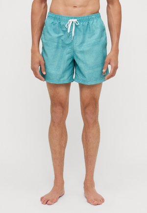 Helle türkisfarbene Badeshorts mit elastischem Bund und weißem Kordelzug. Verfügt über ein strukturiertes Muster mit kreisförmigen Designs.