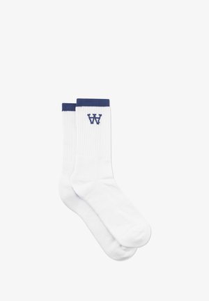 White cotton socks with ribbed texture and a navy blue cuff. Centered logo "W" in navy blue. Standard crew length.