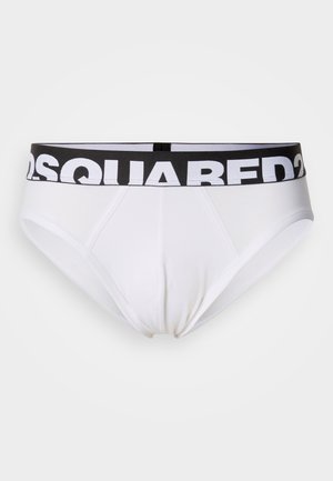 Valge puuvillane aluspüksid musta elastse vöökohaga, millel on julged valged tähed. Klassikaline disain, sile tekstuur ja tihe sobivus.