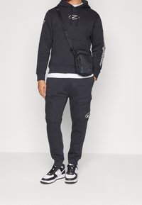 Nike Sportswear Träningsbyxor - black
