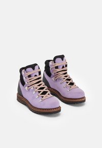 Light purple suede hiking boots with black collars, metal eyelets, and light pink laces. Textured rubber soles for traction.